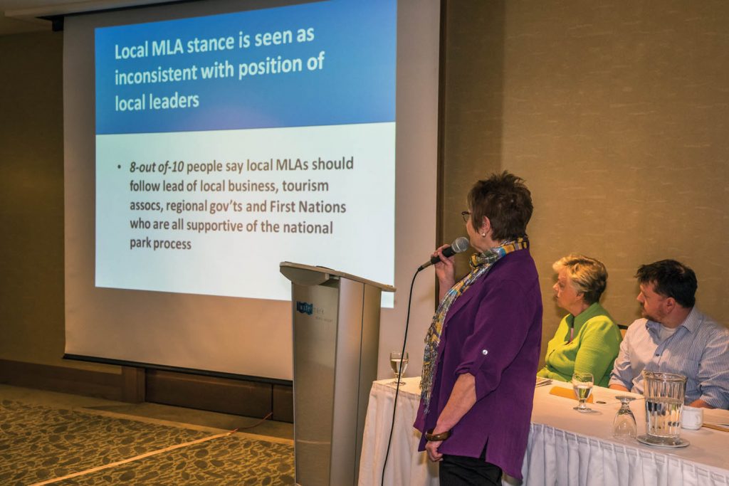 Doreen Olson, co-ordinator of the SOS National Park Network, presented results of an opinion poll in April about support for a national park. The slide she's showing suggests that MLA Linda Larson is out of step with local business, tourism associations, regional governments and first nations who support a park. Looking on are Osoyoos Mayor Sue McKortoff and Chamber of Commerce President Brian Highley. (Richard McGuire photo)