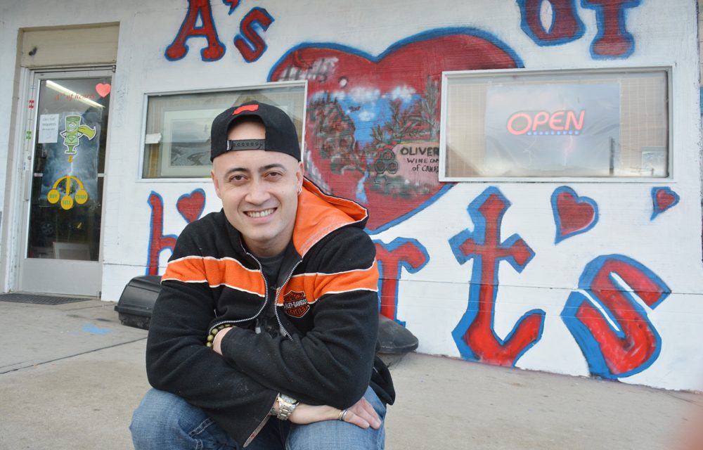 Business owner covers up artwork after bylaw infraction