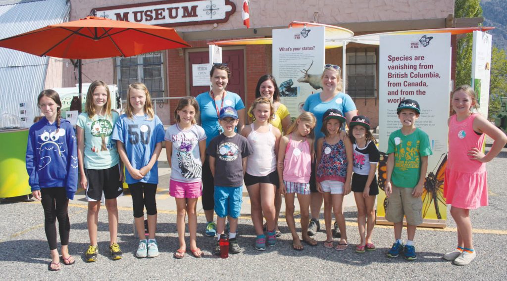 The Royal BC Museum is sponsoring a Species at Risk exhibit across the Okanagan Valley this summer and a dozen local kids signed up to participate in this week’s summer camp at the Osoyoos Museum. Back row are Royal BC Museum summer students Rachelle Linde (far left) and Jenny Arnold (far right), shown with Osoyoos Museum manager Kara Burton. Local kids taking part are (from left) Kaelyn Burton, Kaitlyn Rempel, Ali Rempel, Raegan McFarlane, Logan Fletcher, Becca Knight, Eva Wyse, Brynne McFarlane, Gyll Burton, Charlie Burton and Darcelle Knight. The exhibit will be on display this Saturday at the Osoyoos Market on Main. (Keith Lacey photo)