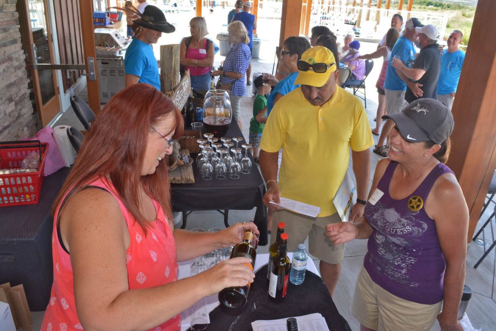 Tammy Betts from Oliver Twist Winery served up countless samples during Family Day at Osoyoos Cottages this past Saturday, July 30. The Cottages on Osoyoos Lake now has more than 100 homes built on the shores of beautiful Osoyoos Lake. Developer Eric Van Maren will continue to build new cottage-style homes at the prestigious subdivision over the next several years. (Dan Walton photo)