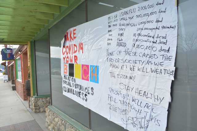 Unwanted COVID-19 sign glued to Oliver storefront