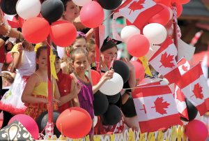 Children celebrate Canada amid a sea of Canadian flags and balloon in this file photo taken at Cherry Fiesta in 2012.