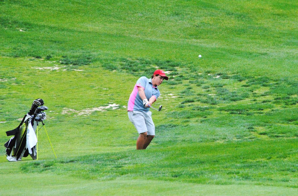 Cole Rezka of Osoyoos Secondary School chips onto the 12th green at Fairview Mountain Golf Club during the South Zone championships May 13. Rezka shot an 87 for the top Rattlers score. (Dale Cory photo)