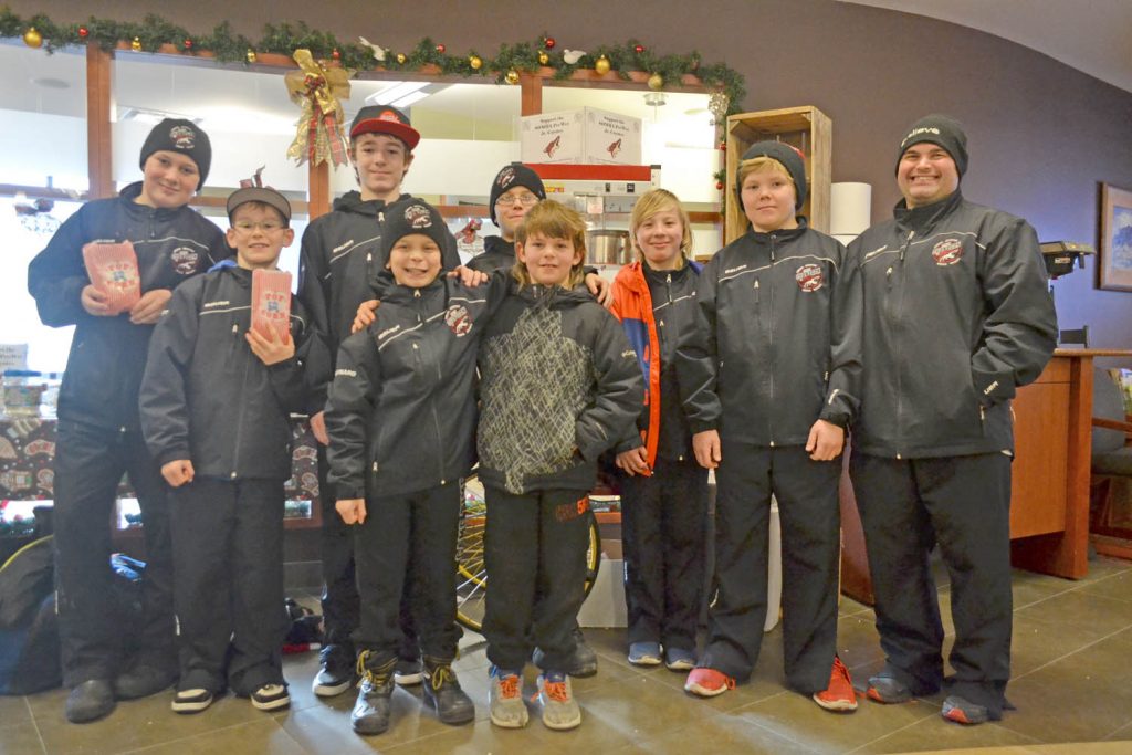 Members of the South Okanagan Minor Hockey Association’s peewee rep team held a fundraiser for local charities at the Osoyoos Credit Union this past Saturday. Head coach Dean Maynard (far right) and his players ended up raising $300, which will go towards gift cards to help local families for the Christmas season. (Trevor Nichols photo)