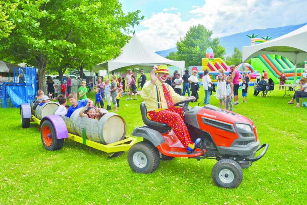 All aboard! Sunny the Clown was the conductor of wine barrel wagon rides at the Oliver Sunshine Festival in the community park on July 8-9. Children and adults had a blast during the event. (Dan Walton photo)