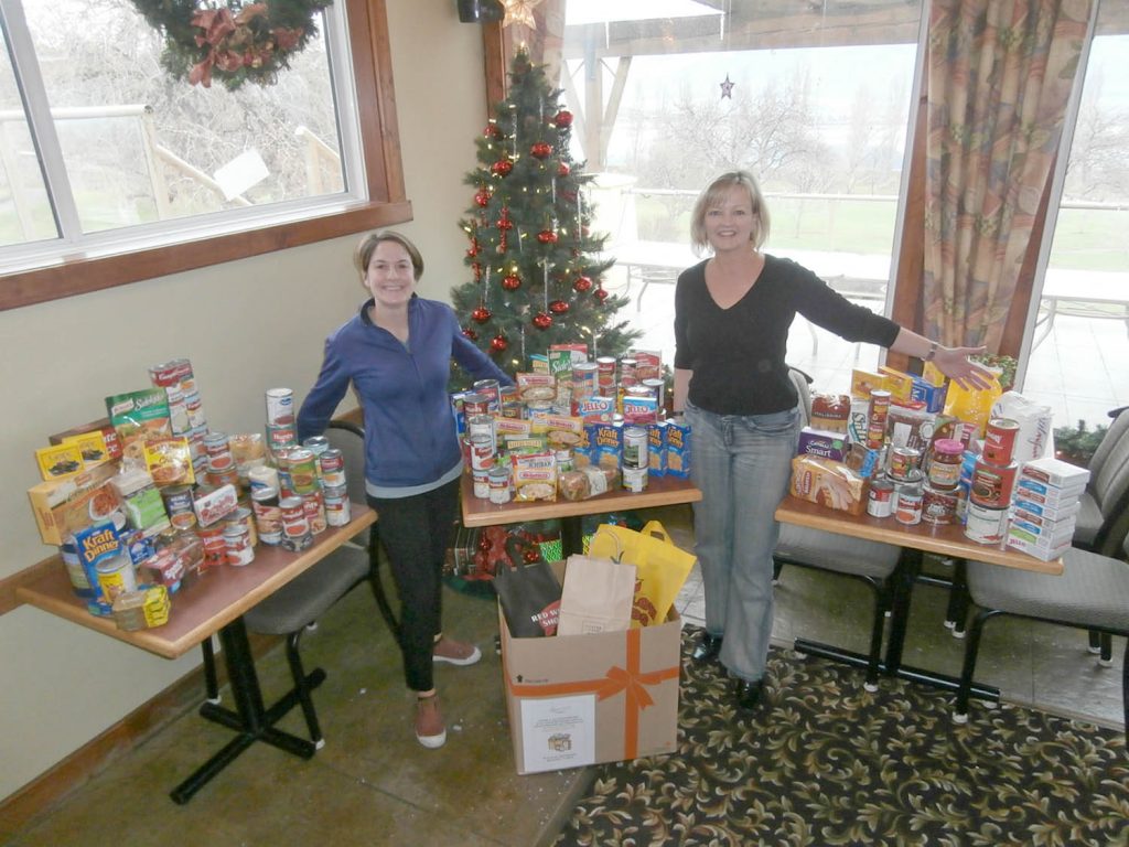 Members from the Osoyoos Golf Club showed up in large numbers during its annual Christmas member appreciation event last week and members donated hundreds of pounds of food for the Osoyoos Food Bank. Anyone who made a donation had a chance to win two tickets to the annual Christmas Dinner being held at the Greenside Grill on Saturday. The event is almost sold out. Proudly displaying the food items donated last week are Diane Butt (left), manager and co-owner of Greenside Grill, and Audrey McCulloch, marketing and member services manager at the Osoyoos Golf Club. Tickets for Saturday’s dinner are still on sale at the Greenside Grill. (Photo supplied)