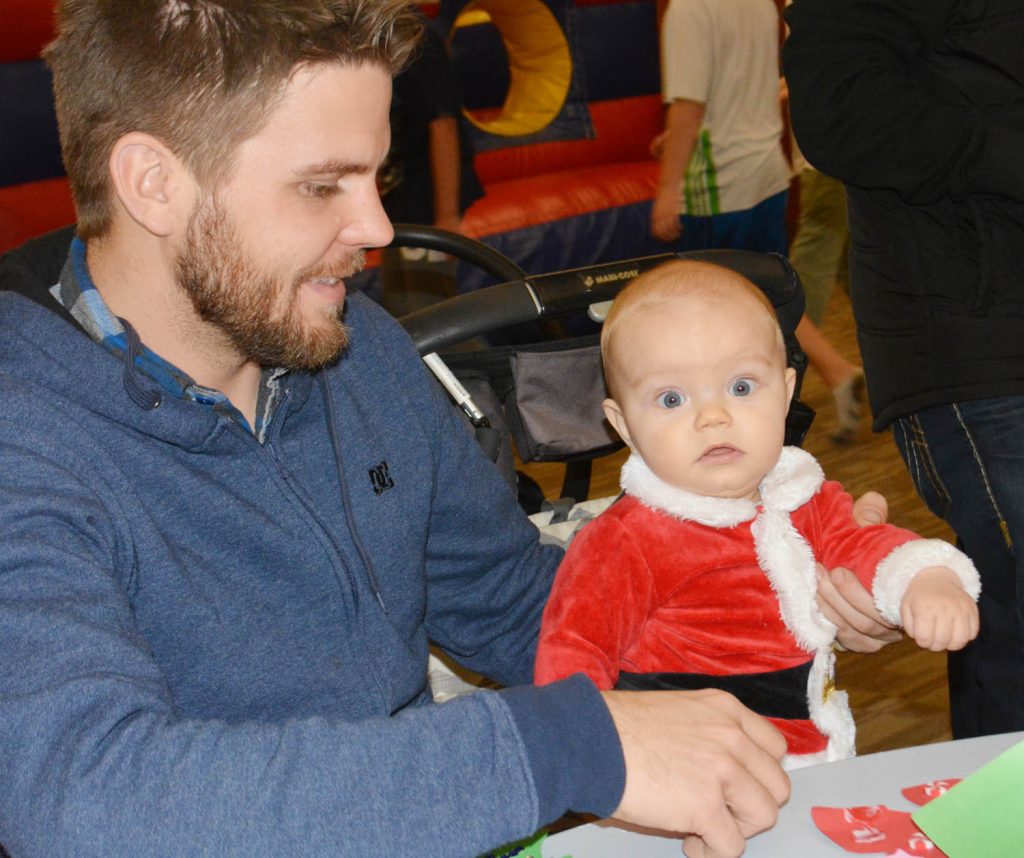 Seven-month-old Quinten Baker from Osoyoos was all eyes while making crafts with dad Lee Baker during the 6th annual Nk’Mip Festival of Trees held at Spirit Ridge Resort and Spa on Saturday, Nov. 28. This is the sixth year for the event and the trees will continue to be on display until Jan. 3. No admission is charged to see the trees, but a small donation is requested with funds going to the B.C. Children’s Hospital Foundation. Other Christmas events kick off on Friday and Saturday downtown with Osoyoos Christmas Lite-Up and other events. (Lyonel Doherty photo)