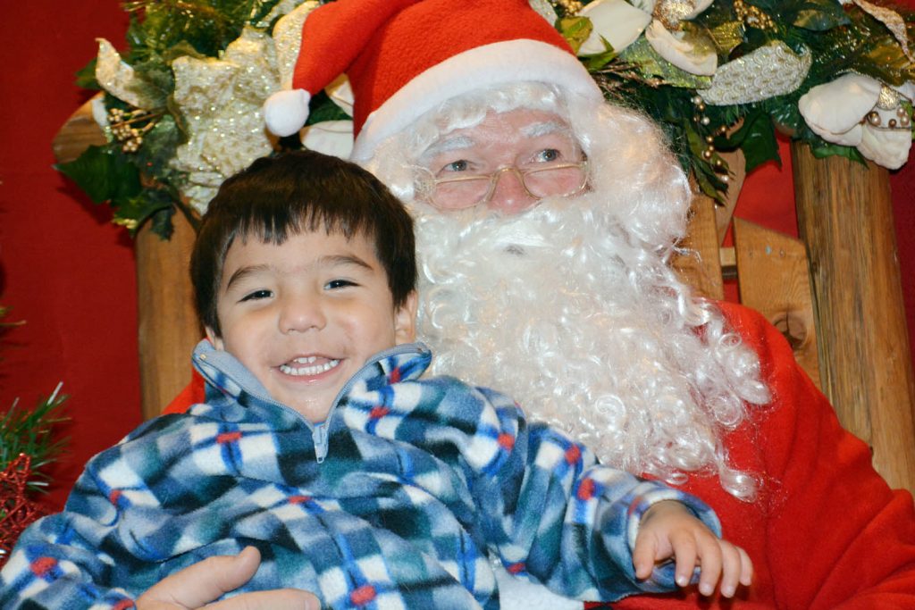 Mark Holgate from Osoyoos was all smiles when he met Santa at Royal LePage realty in Oliver during the Town of Oliver Christmas Light-Up event last Friday. (Lyonel Doherty photo)