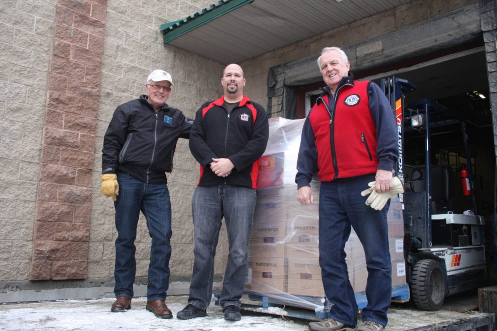 Ed Fossen (left) and Phil Gunhouse (right) are directors with the Kettle River Lions Club. Last week they were in Osoyoos after working out a deal to purchase more than $8,000 in food from AG Foods as part of their annual Christmas hamper program. The food purchased in Osoyoos will go to fill 120 Christmas hampers that will be delivered to families across the Boundary region in towns such as Bridesville, Midway, Greenwood and Rock Creek. AG Foods manager Derek Morgan helped load up the five-ton truck needed to transport the food. (Keith Lacey photo)