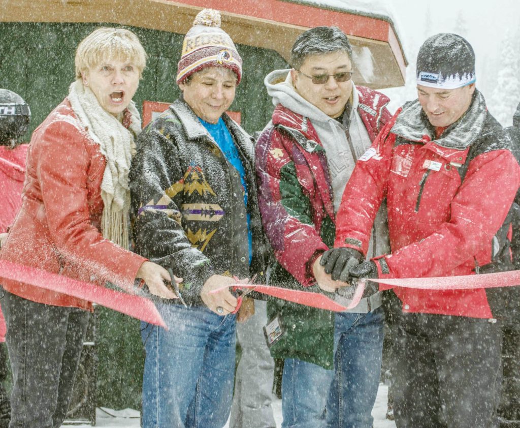 (Left to right) Boundary-Similkameen MLA Linda Larson, Osoyoos Indian Band Chief Clarence Louie, principal investor Victor Tsao and director of operations ‘Snowy’ Joey O’Brien cut the ribbon on Dec. 2 to declare Baldy Mountain Ski Area is open for business again. (Dan Walton photo)