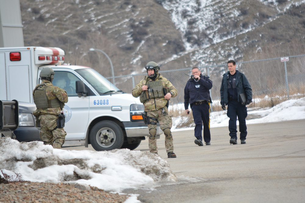 Police gather at their command centre at the Oliver fire hall before attending a residence on Osoyoos Indian Band land. (Lyonel Doherty photo)