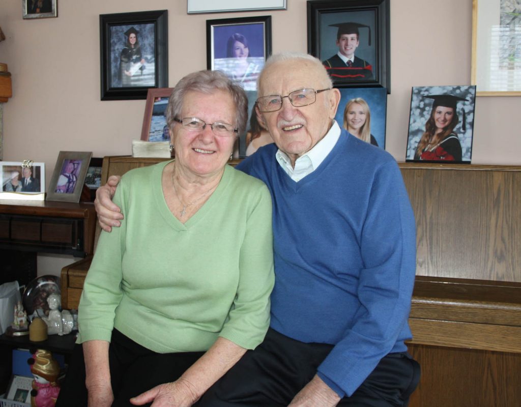 Surrounded by pictures of their children and grandchildren, Tony and Mary Zelko are still in love nearly 60 years after they first met. On their first encounter, Tony pulled out his accordion and started singing. For Mary, it was love at first sight and sound. After the couple married in Rossland 57 years ago, they lived together in Osoyoos. (Keith Lacey photo)