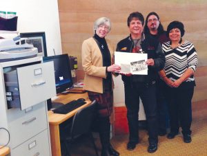 Judith Guichon, Lieutenant Governor of B.C., visited the Nk’ Mip Desert Cultural Centre as part of a two-day visit to the Town of Osoyoos last week. Guichon is seen viewing the new “Historical OIB Photos and Data Entries Project” along with Chief Clarence Louie, cultural centre marketing director Derek Bryson and manager Charlotte Stringam. (Photo supplied) 