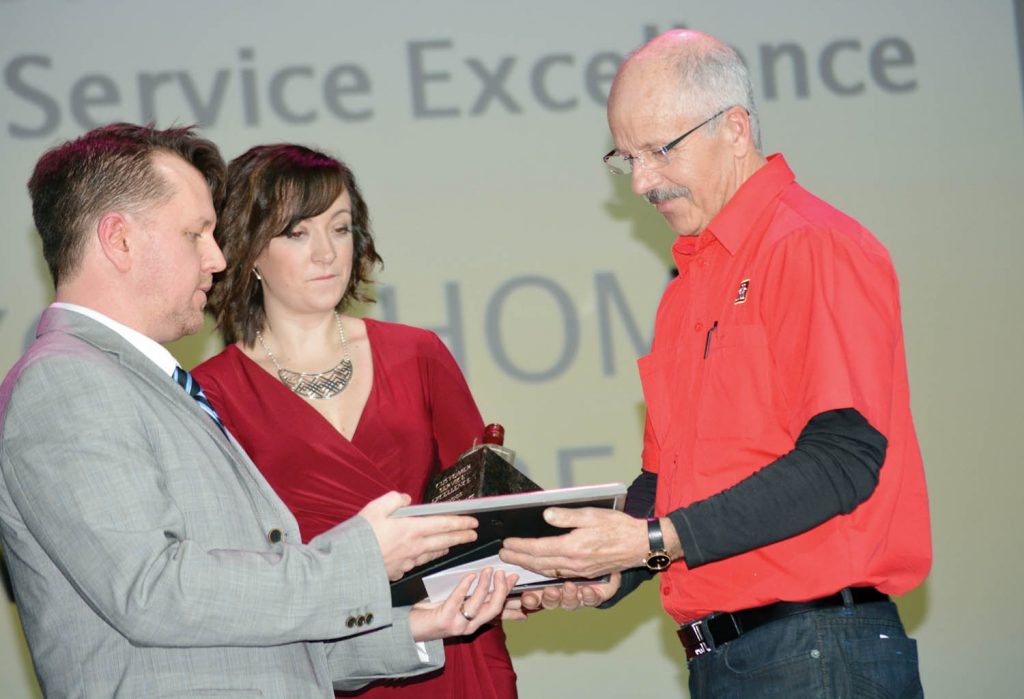 South Okanagan Chamber of Commerce president Brian Highley (left) and Eastlink marketing co-ordinator Yvonne Lalonde present Kevin Ross from Osoyoos Home Hardware with the customer service award at last Friday’s Business Excellence Awards held at Frank Venables Theatre in Oliver. (Lyonel Doherty photo)