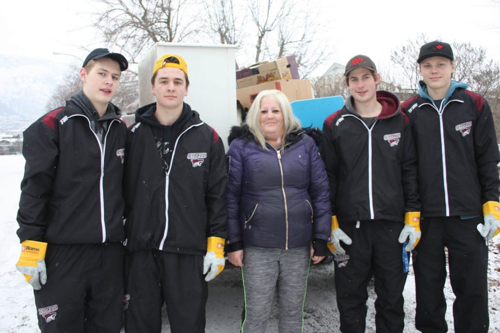 Caitlin Chanell and her family have been overwhelmed by the amount of community support they have received since a house fire forced them from their rented Osoyoos home three weeks ago. Last Friday, Chanell, several friends and these four members of the Osoyoos Coyotes helped clean up the mess caused by the fire and move whatever items were salvageable into her family’s new home in Osoyoos. The Coyotes’ players assisting Chanell (from left) included Kaleb Comishin, Bryson Cecconi, Connor Onstein and Sam Reinbolt. (Keith Lacey photo)