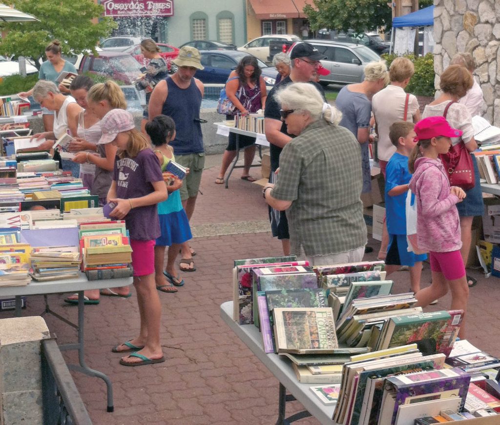People shop for bargains on used books at the Friends of the Library’s annual book sale in 2013. (File photo)