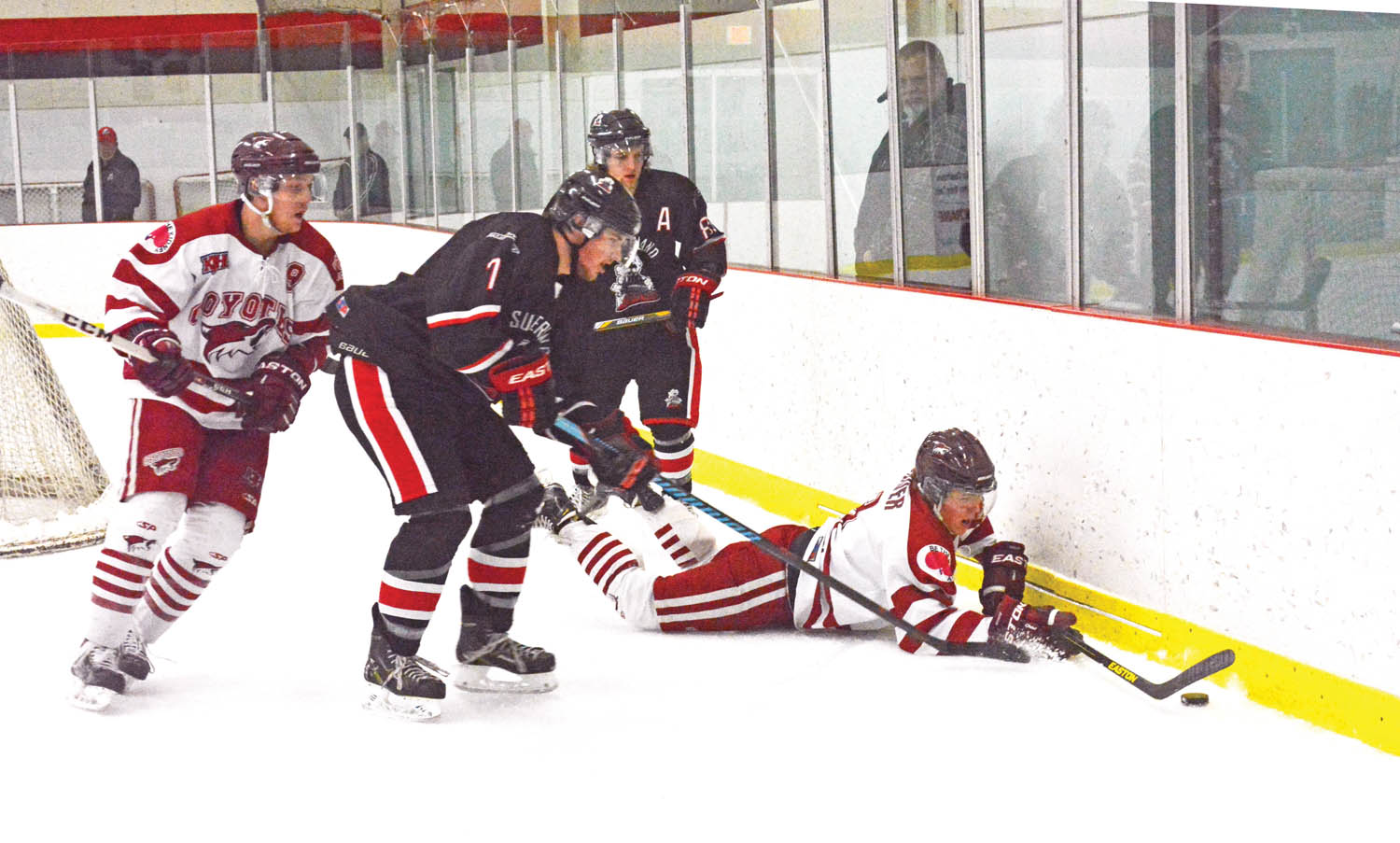 Osoyoos Coyotes and Summerland Steam players battle for the puck in Sunday’s game played in Oliver. (Lyonel Doherty photo)