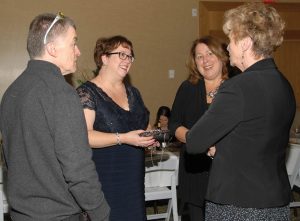 The Desert Sun Counselling and Resource Centre held its annual Grand Night fundraiser this past Saturday evening at the Watermark Beach Resort. A full house helped raise close to $15,000, which will be used to support local programs that benefit women and children in Osoyoos and Oliver. Above, local MLA Linda Larson (far right) chats with Desert Sun staff members Paul and Pamela Edwards and an unidentified woman. (Russell Work Photos)