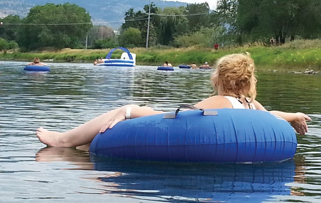 A large group of tubers floats down the Penticton Channel waterway on Saturday. (Trevor Nichols photo)