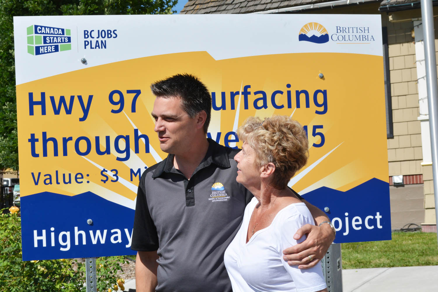 B.C.’s Minister of Transportation and Infrastructure Todd Stone stands with Boundary-Similkameen MLA Linda Larson as they unveil the sign in front of Oliver town hall announcing the $3 million highway upgrade project set to begin next summer. The project will see 25 kilometres of highway resurfacing completed between Osoyoos and Tucelnuit Drive, including Oliver’s main street. (Lyonel Doherty photo)