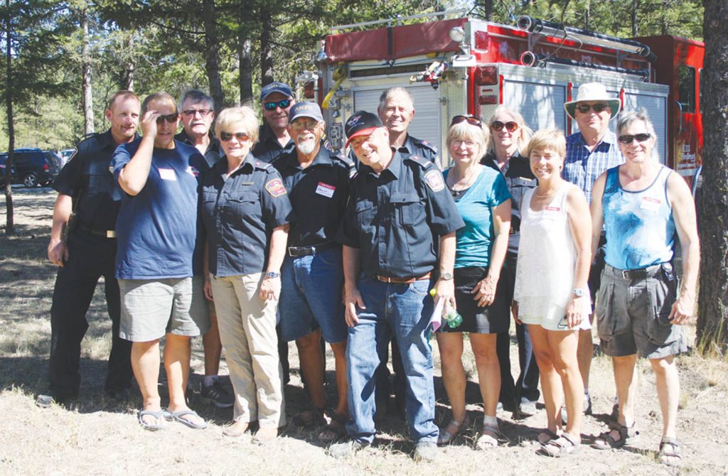 Members of the Anarchist Mountain Community Society are shown with members of the Anarchist Mountain Fire Department during this past Saturday’s annual fundraising BBQ and silent auction, which raises money for the fire department. (Keith Lacey photo)