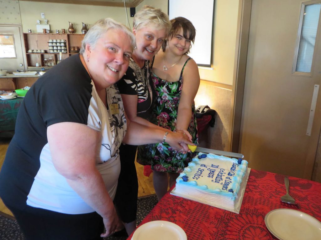 President Allisen Sargent, Mayor Sue McKortoff and former Miss Osoyoos Helen Powers cut the birthday cake to celebrate the Osoyoos Kiwanis Club’s 10th anniversary of serving the community. (Photo supplied)