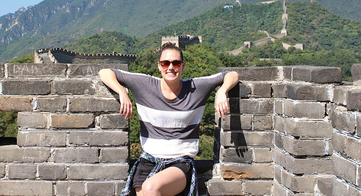 Jamie Munro is the co-owner of Whisper Media in Vancouver, a new video production and marketing company. Munro, whose parents live in Osoyoos, recently spent several weeks in the Osoyoos and Oliver area hoping to attract business from local winery owners. Munro’s company makes short, professional promotional videos. Munro, seen here visiting the Great Wall of China, and her boyfriend are also co-owners of a food and travel website called coupleofyuppies.com. (Photo supplied)