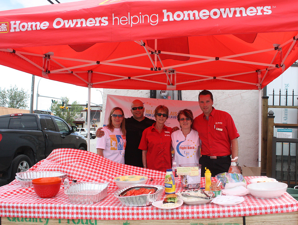 Photo by Keith Lacey The Osoyoos Home Building Centre held its annual Customer Appreciation Day last Friday with staff and volunteers from the Canadian Cancer Society’s upcoming Relay for Life cooking up hamburgers and hot dogs for members of the public. Proceeds from the barbecue will be donated to the Relay for Life, set for June 22 at Gyro Park in Osoyoos. Cooking up a storm were (from left) Lori Wright and Jeff Hildebrandt, both Relay for Life volunteers, Jo-Ann Tessier, an employee at Home Building Centre, Elida Martin, a Relay for Life volunteer and captain of the All for One and One for All team in the 2013 relay, and Home Building Centre manager Travis Loudin.