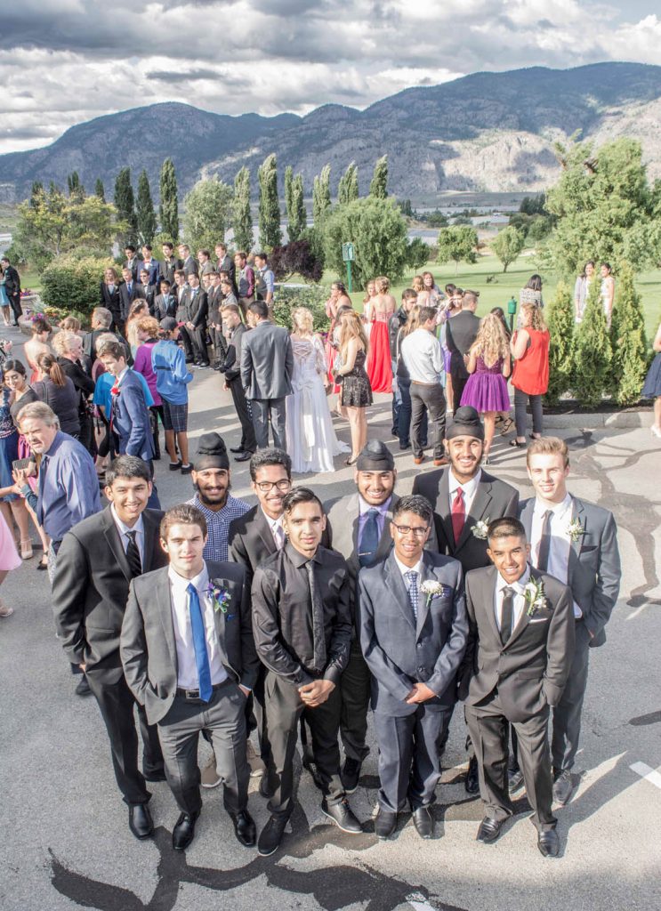A group of students poses for an informal photo as others mill in the background. (Dan Walton photo)