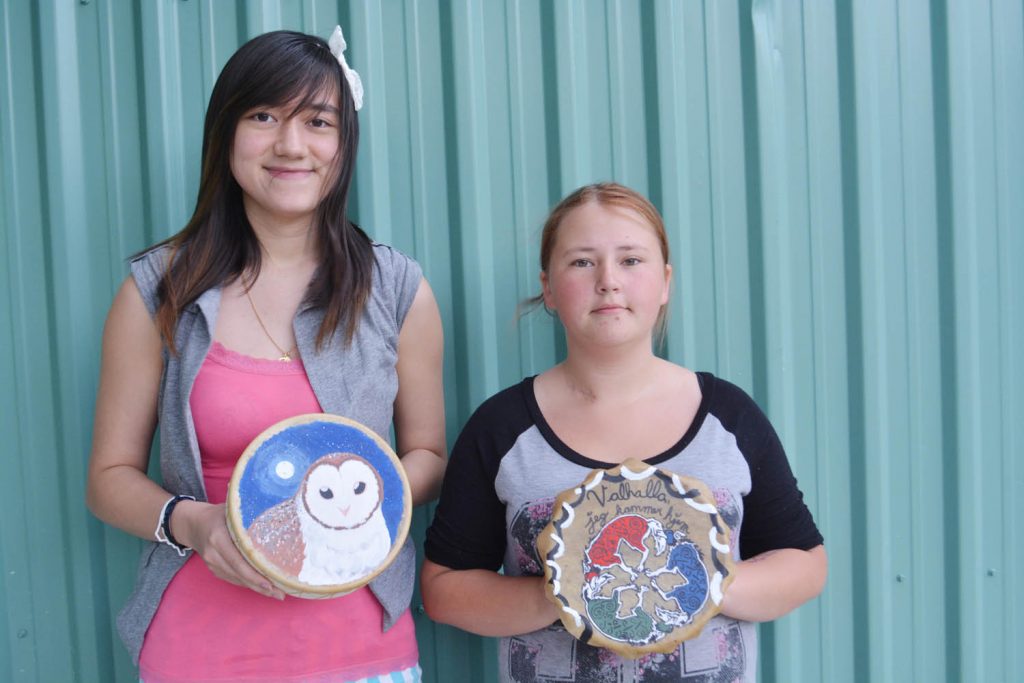 Tina Raposo (left) and Hannah Loseth from Southern Okanagan Secondary School show off their drum-making project as part of the Take-a-Risk grant program in School District 53. (Lyonel Doherty photo)