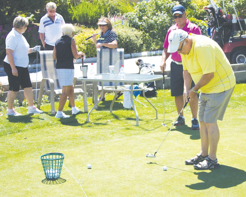 The Osoyoos Rotary Club held its annual golf tournament this past Saturday at Osoyoos Golf Club and more than 80 golfers showed up to participate in the annual event. As has become tradition, the day of golf begins with a putting contest on the putting green as players attempt five putts to try and sink a 50-foot putt to win prizes. Above, Myers Bennett, the past president of the South Okanagan Chamber of Commerce, shows some fine form in lining up his putt. (Keith Lacey photo)