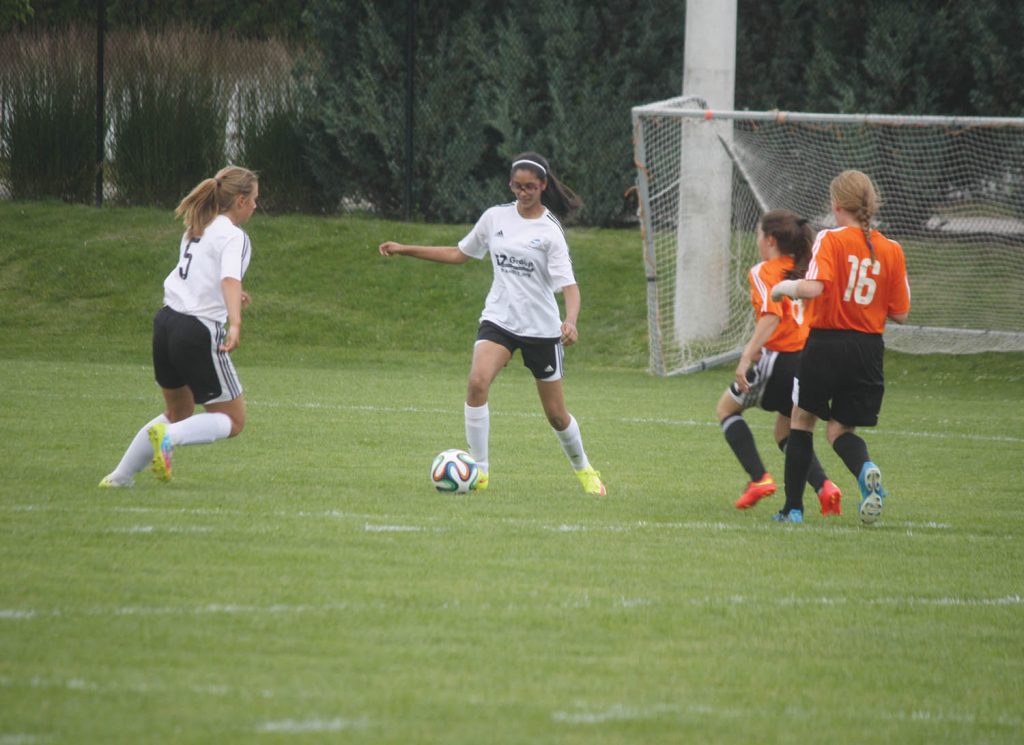 The players with the Osoyoos girls Under 13-14 team captured the Pinnacles Football Club (FC) age division championship this past weekend at the Kings Park soccer complex in Penticton. The Osoyoos boys Under 13-14 team also captured its age division against teams from across the South Okanagan. In action above, girls from the Osoyoos team (white jerseys) battle for a loose ball against the team from Summerland. We will have full coverage of these two teams winning their league titles in next week’s edition of the Osoyoos Times. (Keith Lacey photo)
