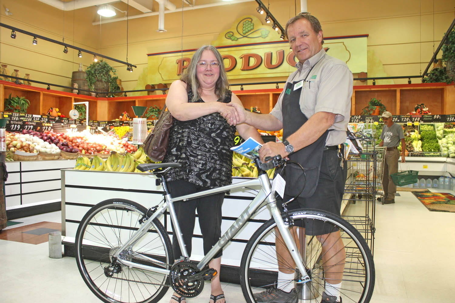 For the past several years, Osoyoos Family Foods has been holding a draw every summer to award a new bicycle and barbecue to loyal customers. Shown here, Grocery manager Bob Irwin presented a new bicycle to Osoyoos resident Tammy Svendsen. (Keith Lacey photo)