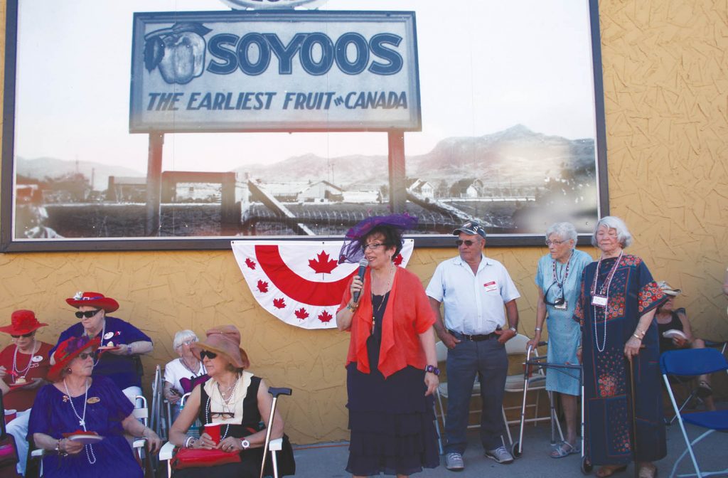 Frances Sologuk, owner of Osoyoos Home Hardware, unveils one of five murals erected on the side of the store while she stands beside town pioneers Gerald Pendergraft, Iris Tweedy and Ruth Schiller. Several hundred local residents -- and many tourists -- gathered outside the store as Sologuk and her husband Larry unveiled the murals that celebrate the town's historic past. (Keith Lacey photo)