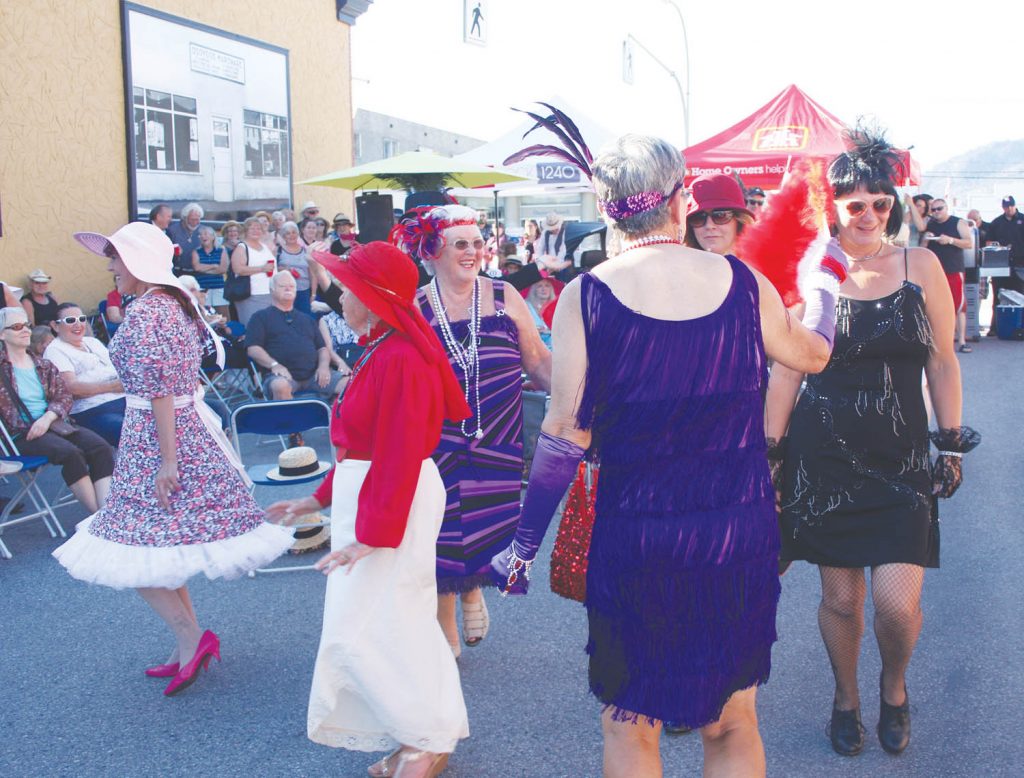 A large and enthusiastic crowd showed up outside the Osoyoos Home Hardware store on Sunday evening as the store unveiled five new murals that honour the town’s pioneers and proud history. A group of about two dozen men and women got into the spirit while wearing clothes of the 1920s and 1930s. (Keith Lacey photo)