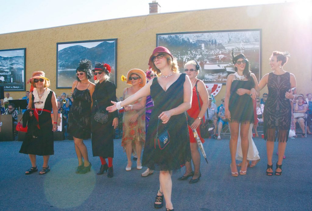A large and enthusiastic crowd showed up outside the Osoyoos Home Hardware store on Sunday evening as the store unveiled five new murals that honour the town’s pioneers and proud history. A group of about two dozen men and women got into the spirit while wearing clothes of the 1920s and 1930s. (Keith Lacey photo)