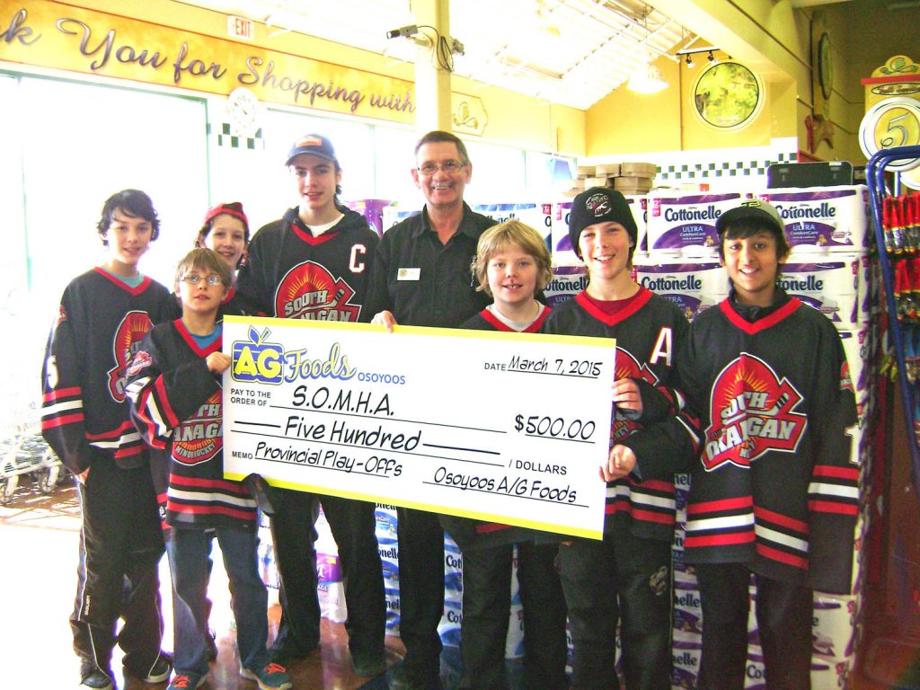 New AG Foods store manager Greg Poirier holds a $500 cheque donated by the store to help pay the costs for the South Okanagan Minor Hockey Association (SOMHA) teams travelling to provincials. (Photo supplied)