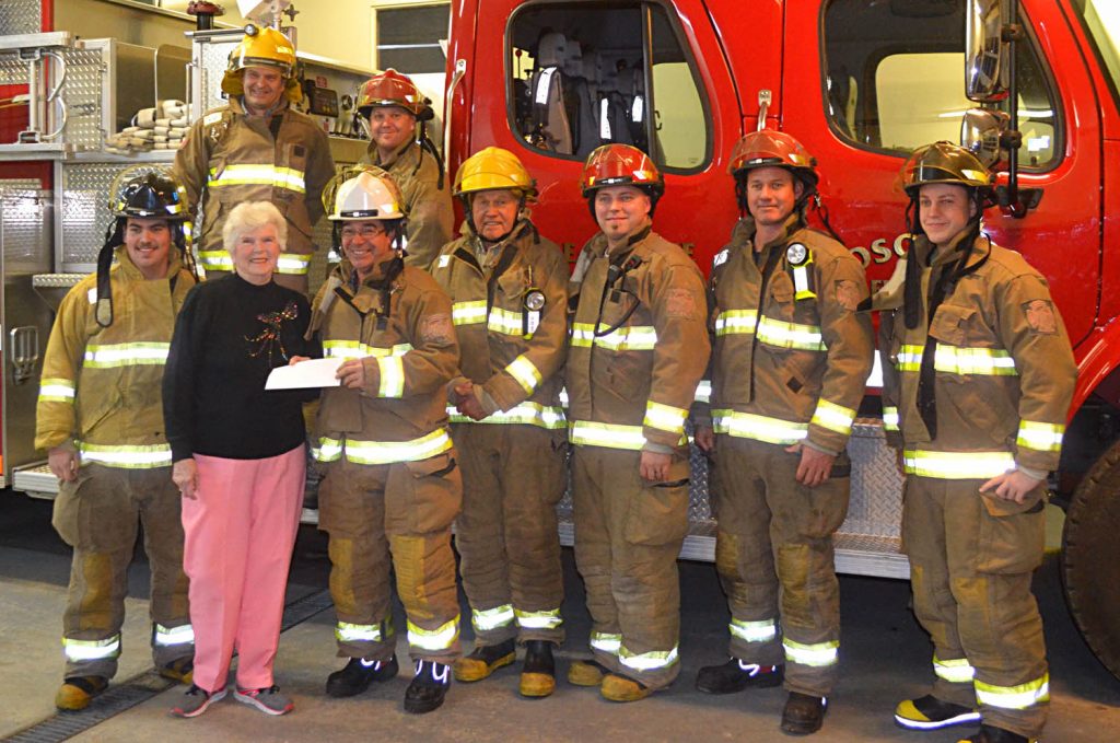 Jean Sherriff, president of the Dorcas Ladies of the Osoyoos United Church, presents a $1,000 cheque to the Osoyoos Volunteer Fire Department recently at the fire hall. The money is earmarked to help pay for firefighter training. The Dorcas Ladies raise money through the United Church Thrift Store, which is staffed by volunteers from the group. Last year, Dorcas Ladies donated about $24,000 to various local non-profits and charities. Volunteer firefighters on hand for the presentation were, front row (left to right) Blake Loura, Sherriff, Bill Rogue, Garth Kunz, Todd Kunz, Wyatt Thomson and Dustin Currell. In the back row were Colin Lancaster (left) and Ryan McCaskill. (Photo supplied)