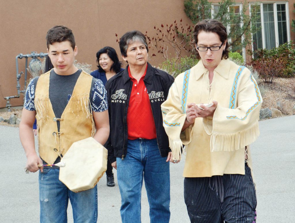 Osoyoos Indian Band Chief Clarence Louie follows Noah Bower (left) and Kxansulaxw Hall during a smudging ceremony as part of the rededication of Spirit Ridge at Nk’Mip Resort on Sunday. (Lyonel Doherty photo)