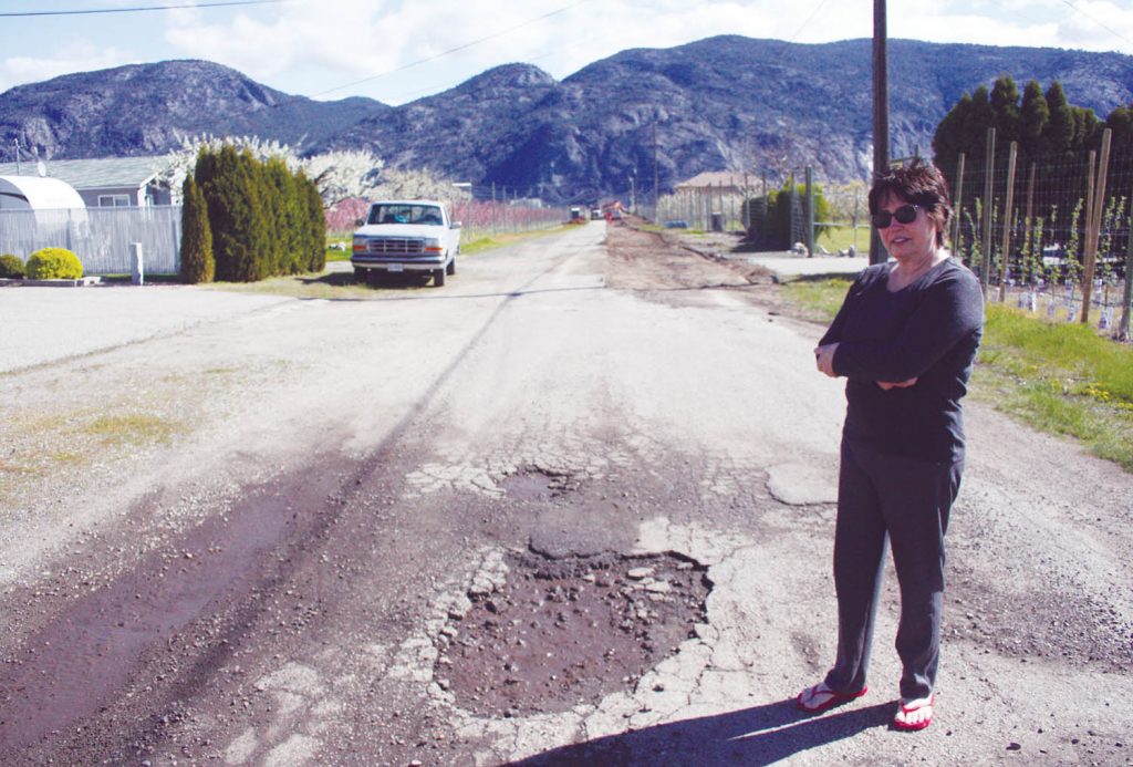Jerralynn D’Alfonso, who owns a home on 100th Street just outside Town of Osoyoos boundaries, is upset and frustrated that the street will only be half paved when a infrastructure project to replace water pipes and install fire hydrants is completed in the next week or so. (Keith Lacey photo)
