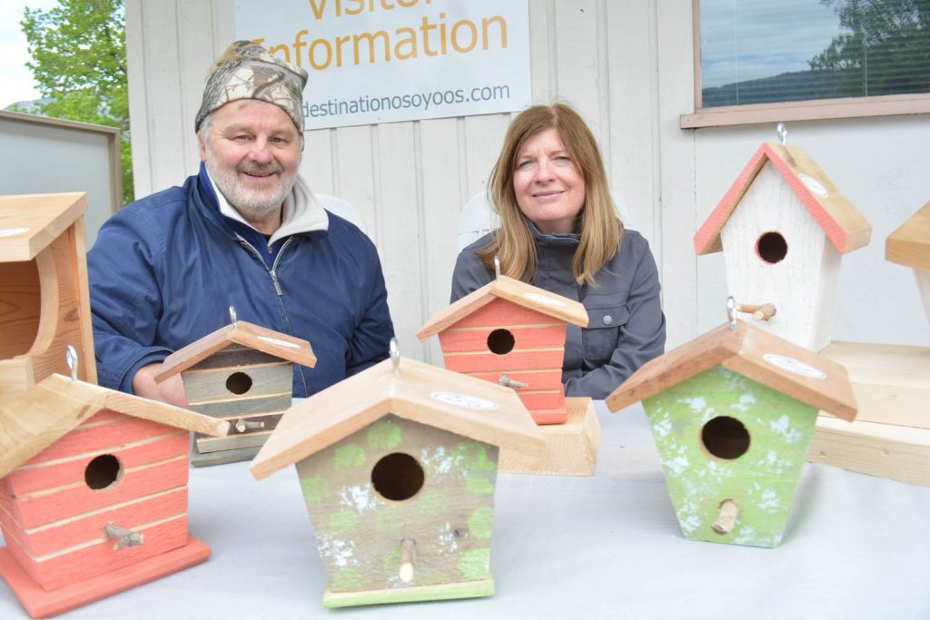Ken and Kornelia Kullberg from Okanagan Falls display their Humble Lumber design birdhouses at Market on Main in Osoyoos on May 6. The Kullbergs are new to the market and their birdhouses attract a lot of attention. (Lyonel Doherty photo)