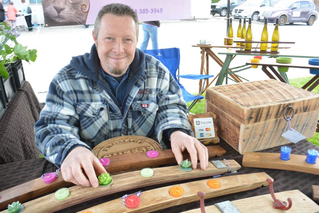 Chris Wolfe from Cat-titude Creations displays his wine barrel staves that make unique tea light holders. Chris and his wife Su Wolfe were among several artisans who took part in last Saturday's Market on Main. (Lyonel Doherty photo)
