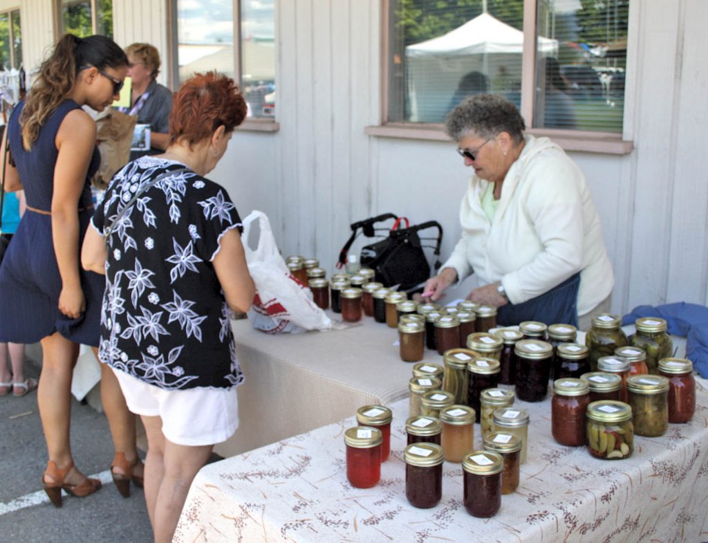 The Osoyoos Market on Main opened for the 2015 season this past Saturday morning and there was a very nice crowd on hand as hundreds of people flocked to the local market to check out the various vendors and enjoy the beautiful weather and sunshine. Longtime vendor Lyn Silverthorn was selling her popular homemade jams and jellies. (Keith Lacey photo)