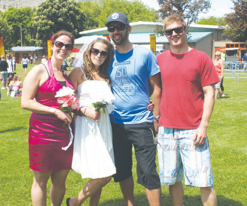 Rachel Jacobs and Iain Mill (centre) were married at Spirit Ridge Vineyard Spa and Resort only hours after Jacobs competed in her first Half Corked Marathon on Saturday. Joining them when they exchanged wedding vows were their good friends Melanie and Andy, who also brought their two children to the special ceremony. (Keith Lacey photo)