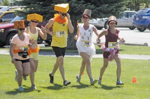 People with cheese heads ran in last year’s Half Corked Marathon in this file photo. (Keith Lacey file photo)