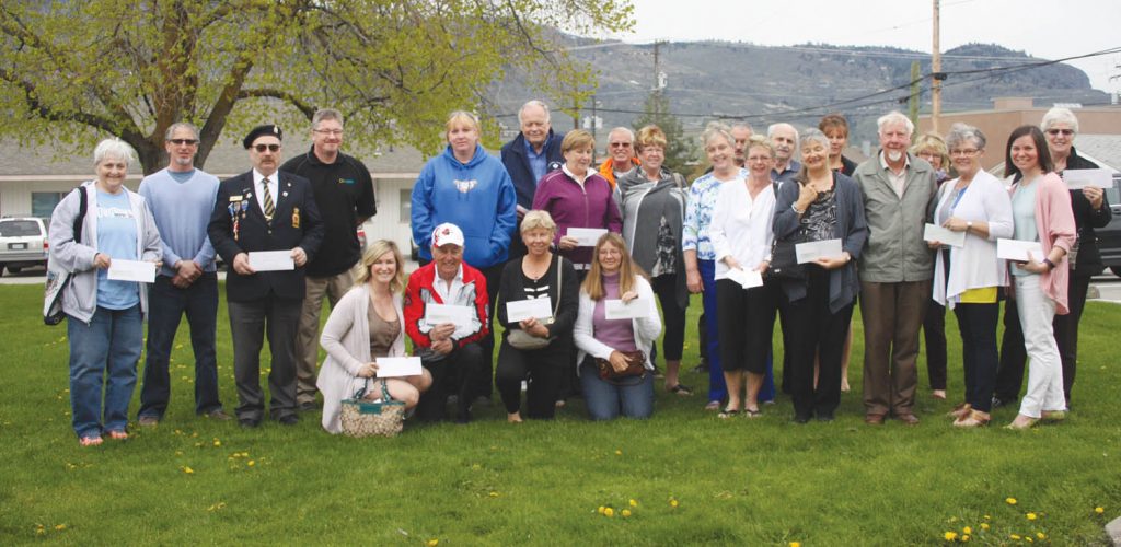Representatives from more than a dozen community non-profit groups and organizations posed for this photo with members of Town of Osoyoos council and senior administration outside town hall Monday after council handed out cheques totalling $58,000 through its community service grants program. (Keith Lacey photo)