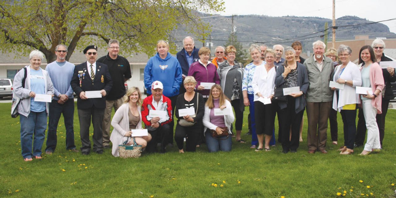 More than a dozen community groups and organizations pick up cheques from town
