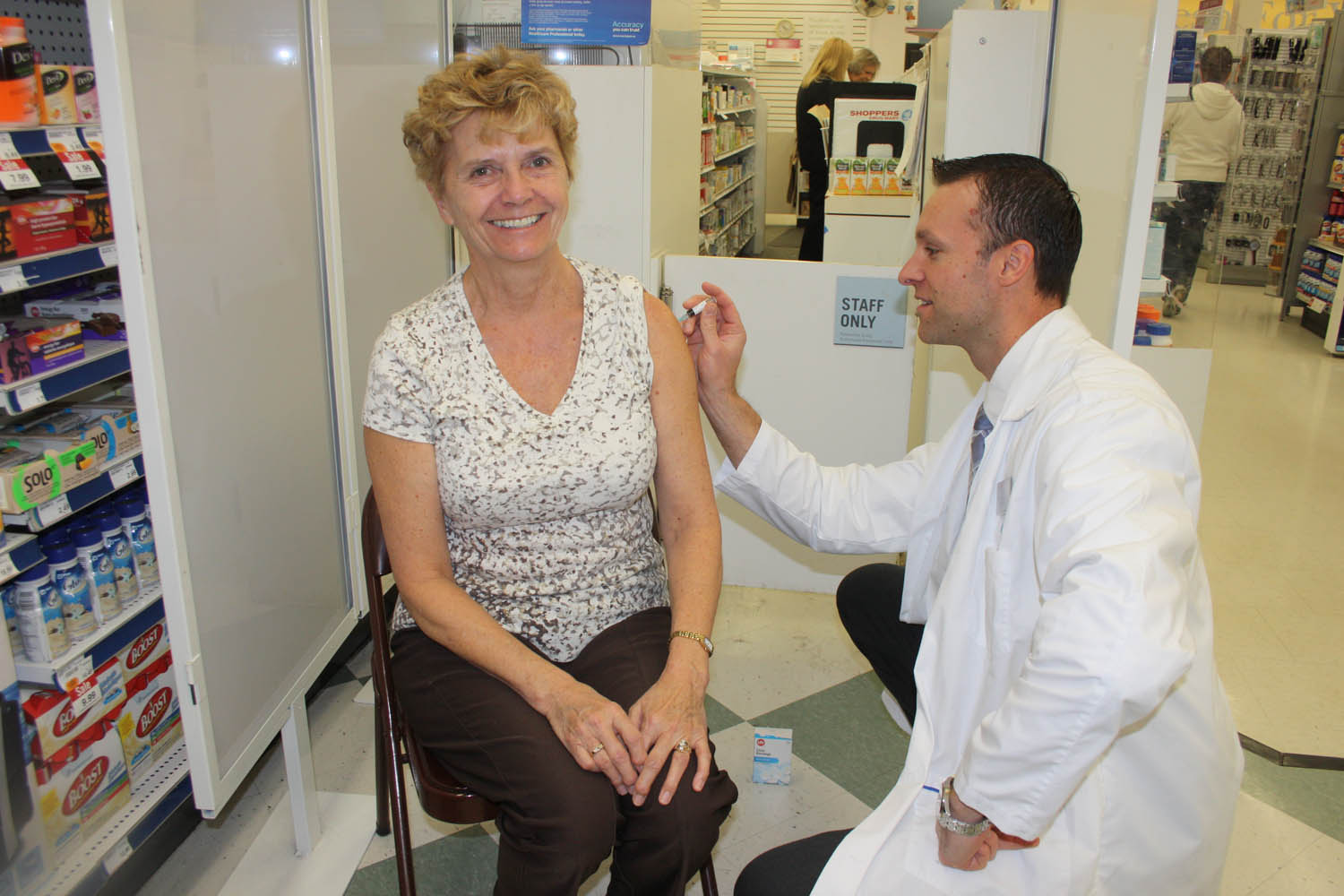 MLA Linda Larson was in Shoppers Drug Mart in Osoyoos on Monday to get her seasonal flu vaccination. Doing the honours was Steven Hopp, pharmacist and associate owner of the store. Hopp encourages everybody, especially those at greatest risk, to get the flu vaccine. (Keith Lacey photo)
