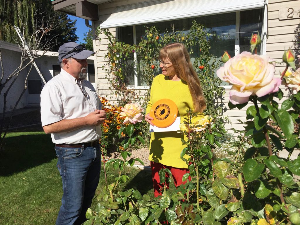 Kevin Salvali of KelownaGardens.com presents some of the prizes in the Okanagan Basin Water Board’s WaterWise contest to Felicia Taylor of Osoyoos. Taylor and her partner Rob Abbott shared the $6,000 grand prize. (Contributed photo)