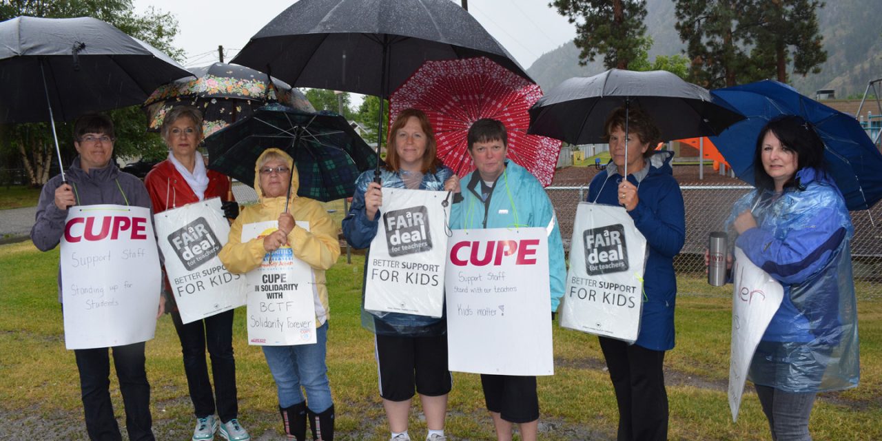 Teachers brave the rain for rotating strikes